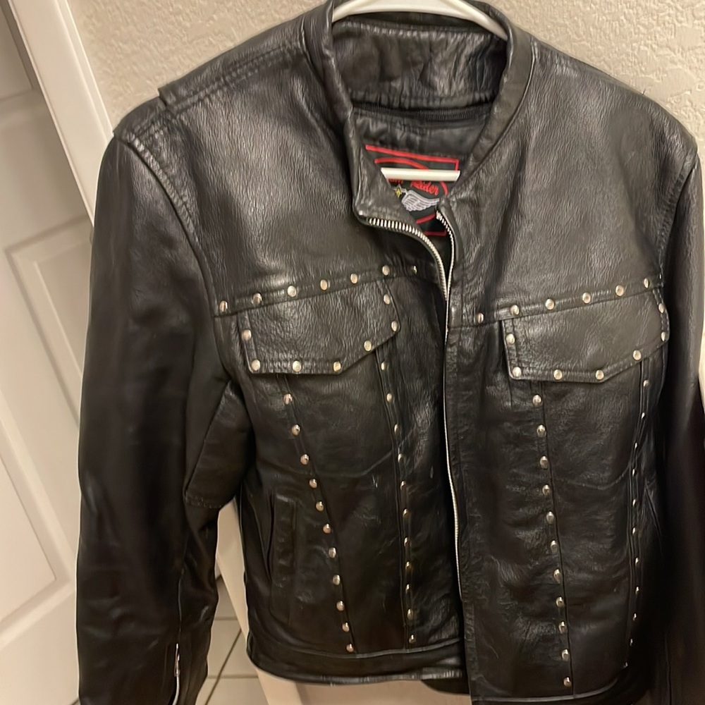 Women’s Black leather jacket with silver studs.
